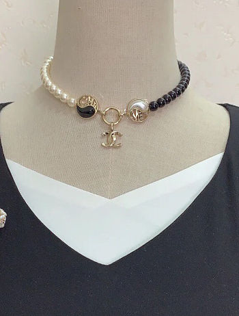 Chanel necklace is the A23C Pearl Coco Mark